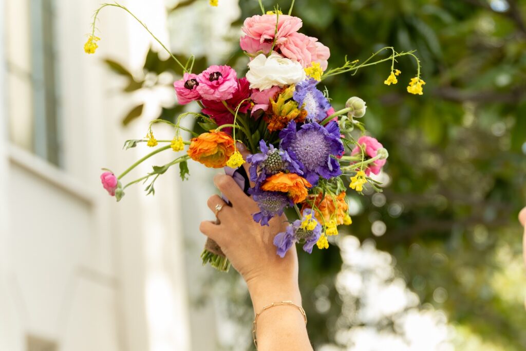 Hand holding a vibrant garden bouquet