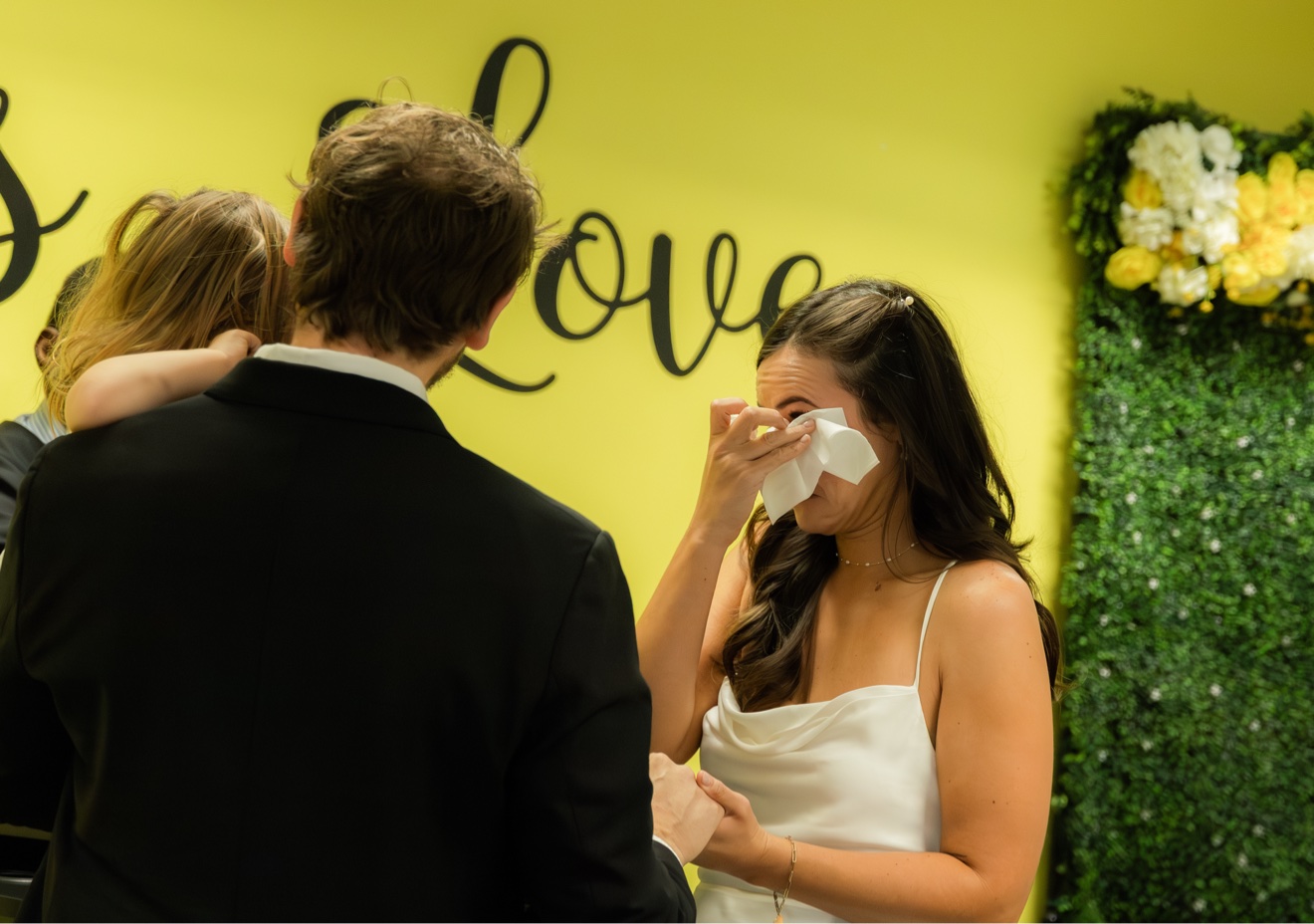 Bride smiling through tears during the wedding ceremony