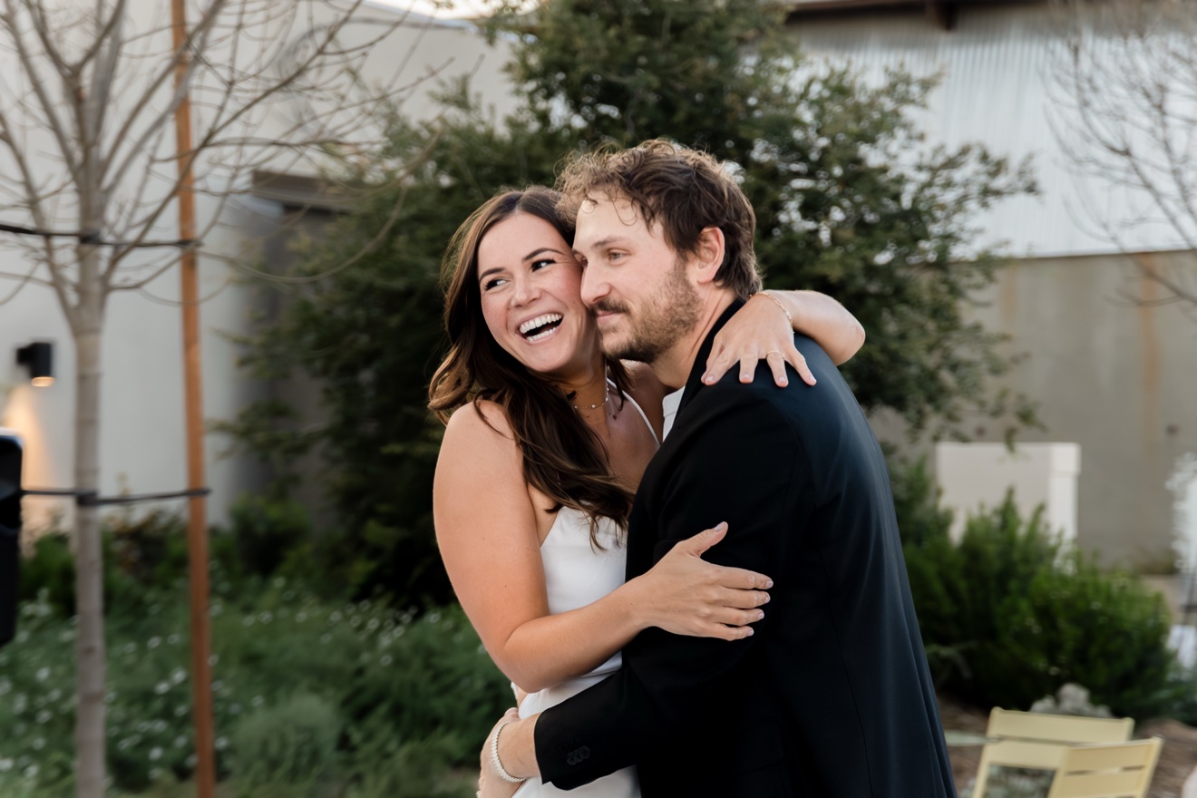Wedding couple laughing in a close embrace