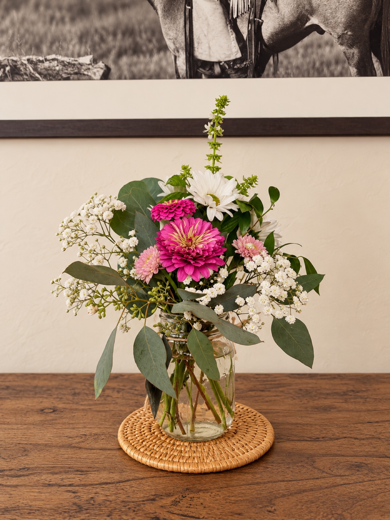 Petite mason jar arrangement with pink zinnias, white daisies, baby's breath, and eucalyptus