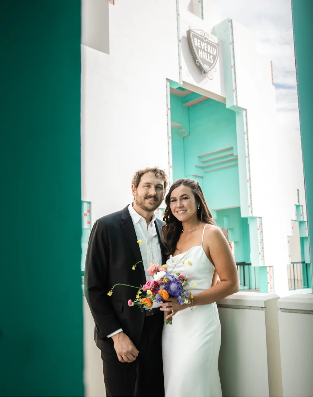 A wedding couple in front of the Beverly Hills sign