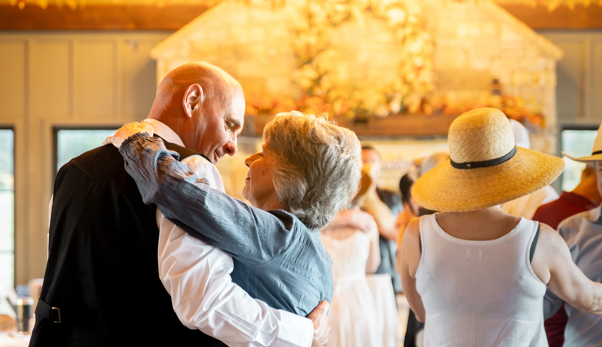 An older couple dancing together at a celebration