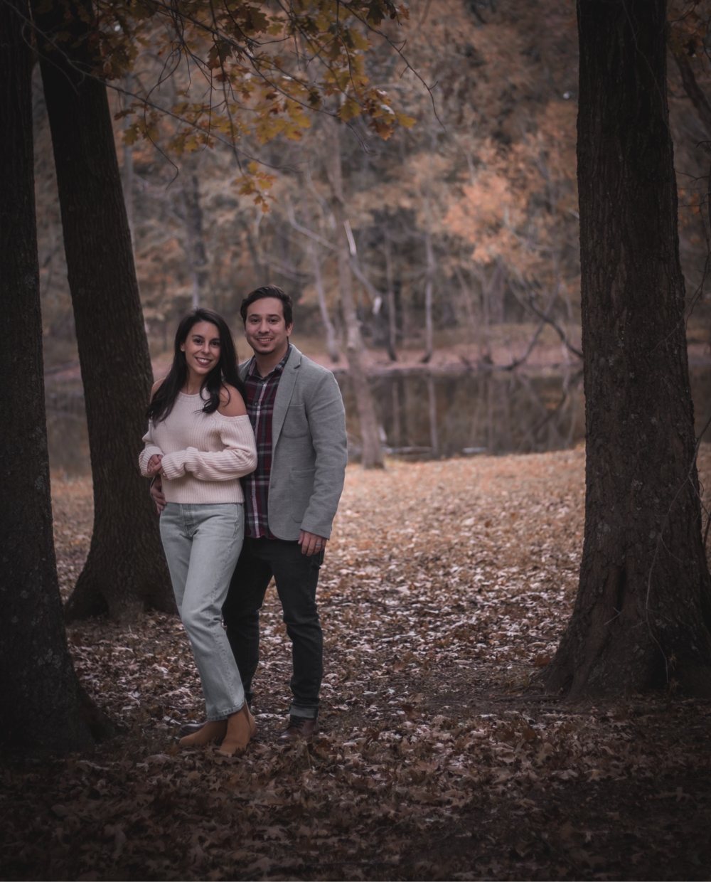 Bea and Alex, the husband-and-wife team behind Thistle & Thyme, standing together in autumn woods